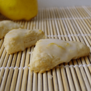 Three Mini Lemon Scones with lemon glaze on bamboo mat