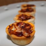 Finished pizza pie bites on a serving platter.