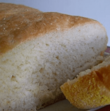 Loaf of english muffin bread with a slice cut off