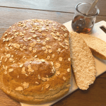 Sliced maple oat bread on a cutting board