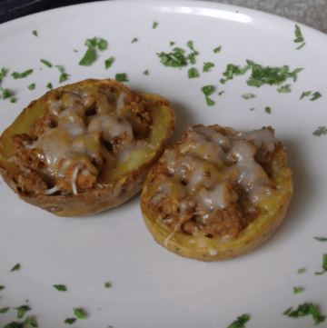 Two taco stuffed potato skins on a plate