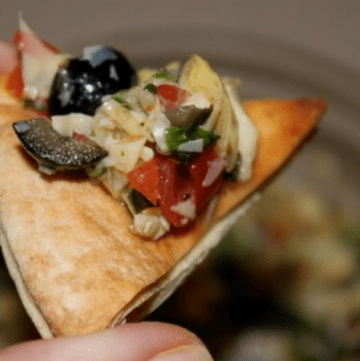 prepared artichoke salsa on a pita chip